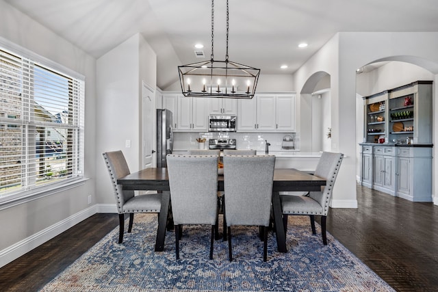 dining area featuring an inviting chandelier and dark hardwood / wood-style floors