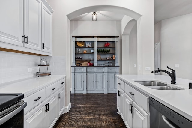 kitchen with white cabinetry, sink, tasteful backsplash, and stainless steel dishwasher