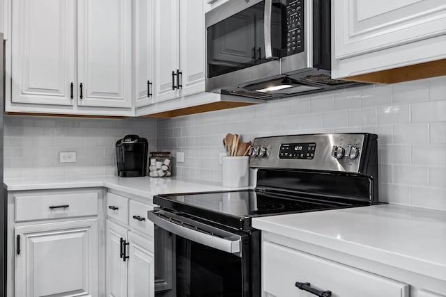 kitchen with appliances with stainless steel finishes, decorative backsplash, and white cabinets