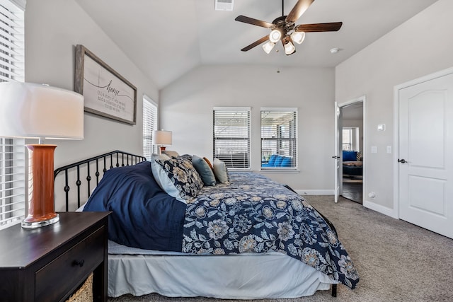 carpeted bedroom with multiple windows, vaulted ceiling, and ceiling fan