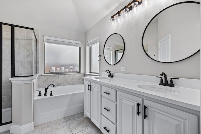 bathroom with shower with separate bathtub, vaulted ceiling, and vanity