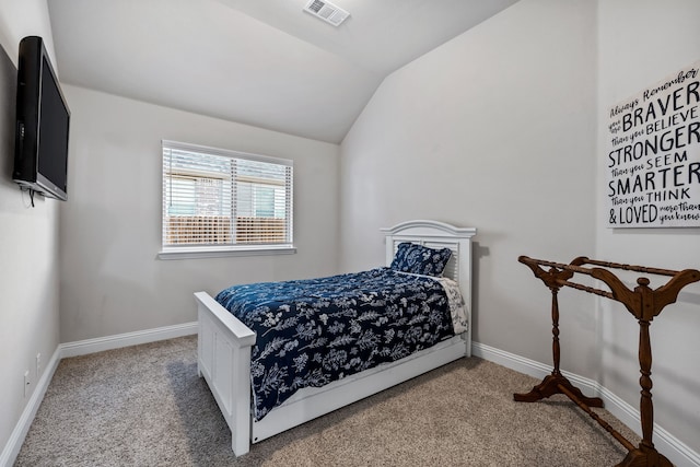 bedroom with lofted ceiling and carpet flooring