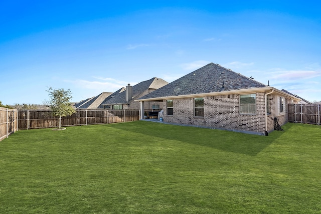 back of house featuring a lawn