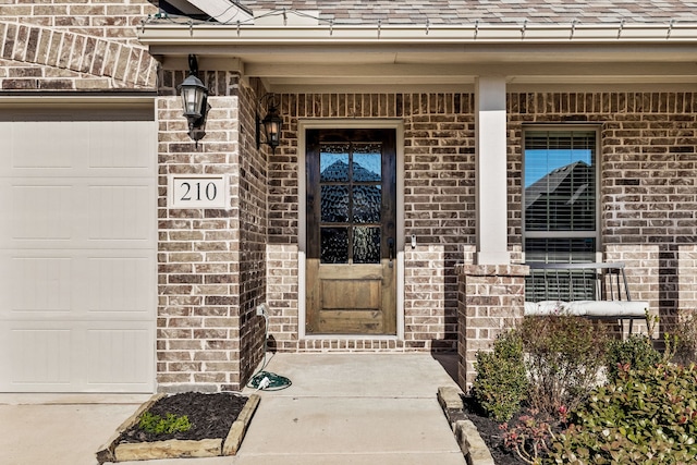 view of exterior entry featuring a garage