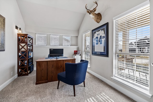 home office featuring light colored carpet and vaulted ceiling