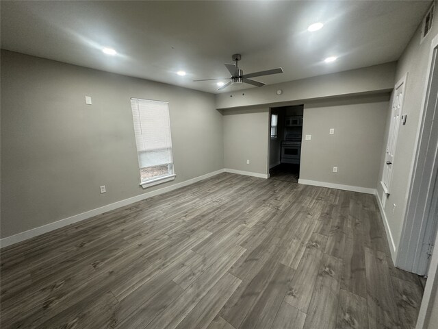 unfurnished bedroom with dark hardwood / wood-style flooring and ceiling fan