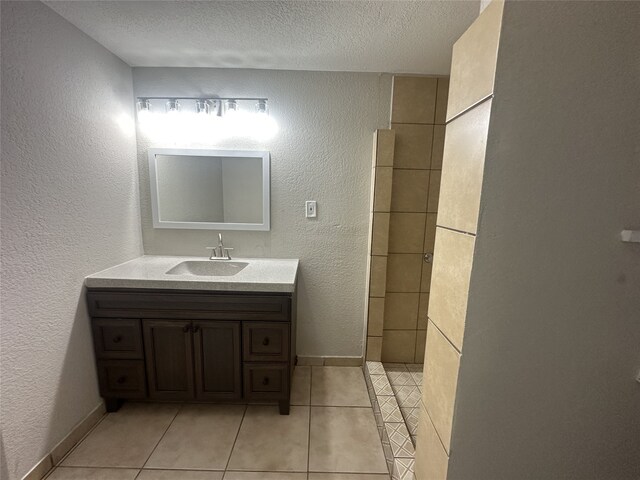 bathroom with vanity, tile patterned floors, and a textured ceiling