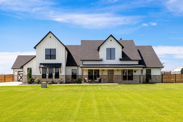 rear view of house featuring a lawn