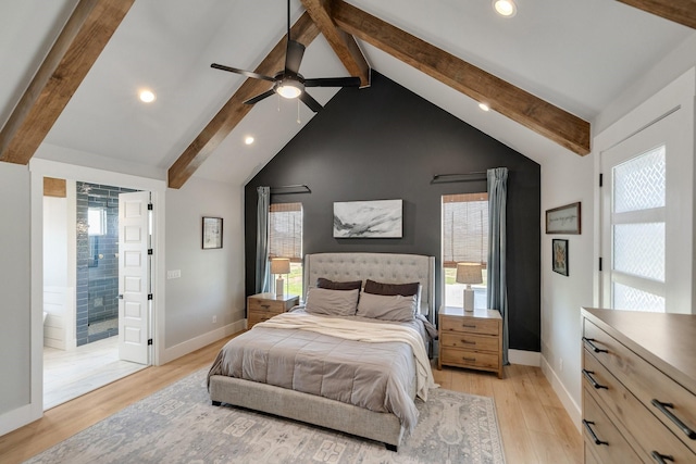 bedroom featuring vaulted ceiling with beams, ceiling fan, light hardwood / wood-style floors, and connected bathroom