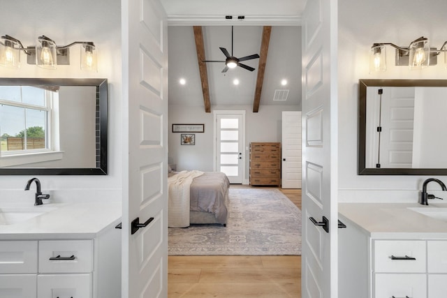 bathroom featuring ceiling fan, beamed ceiling, vanity, and hardwood / wood-style floors