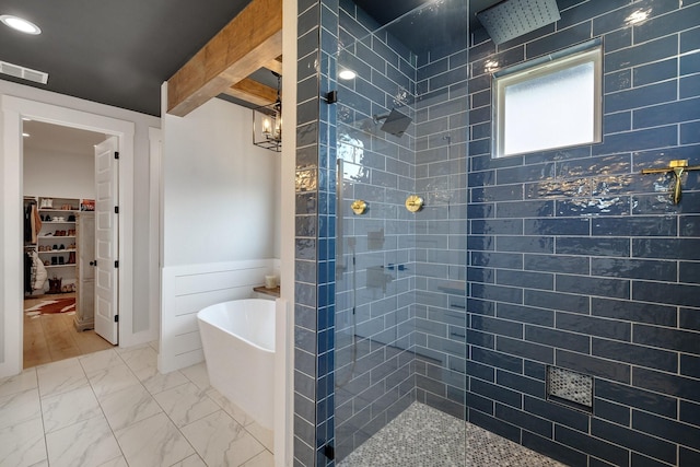 bathroom featuring plus walk in shower and a notable chandelier