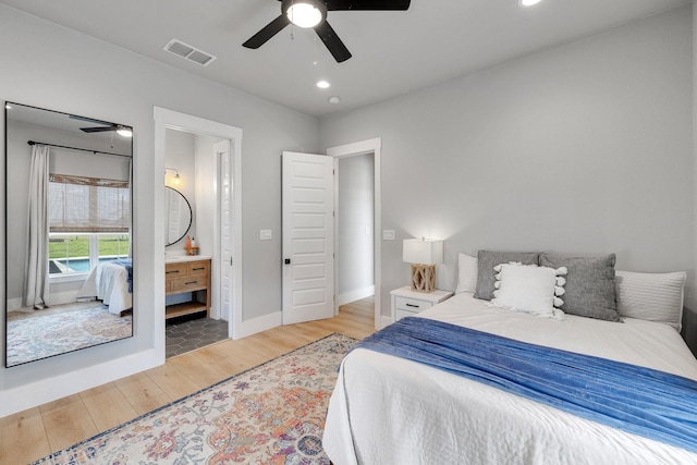 bedroom featuring ensuite bath, ceiling fan, and hardwood / wood-style floors