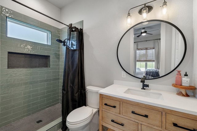 bathroom featuring ceiling fan, toilet, vanity, and a shower with shower curtain