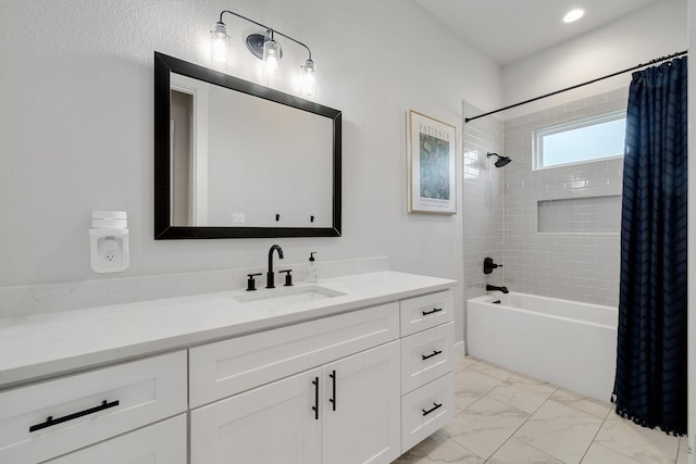 bathroom featuring shower / bath combo and vanity