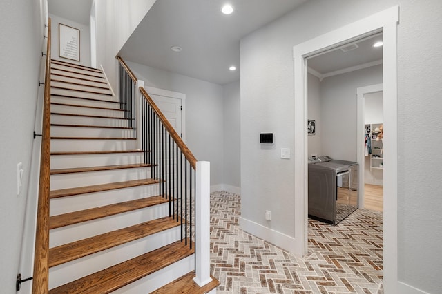 staircase featuring washer and dryer and crown molding