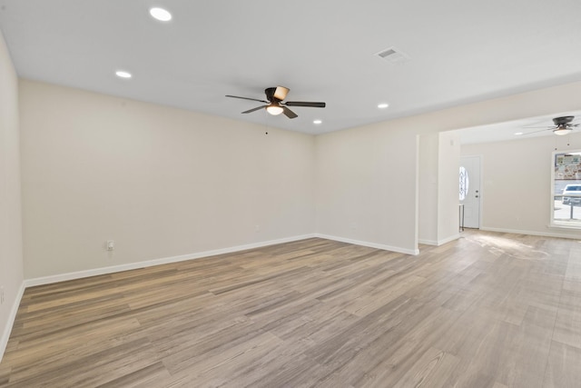 empty room featuring ceiling fan and light wood-type flooring