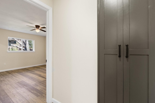 corridor with light hardwood / wood-style flooring