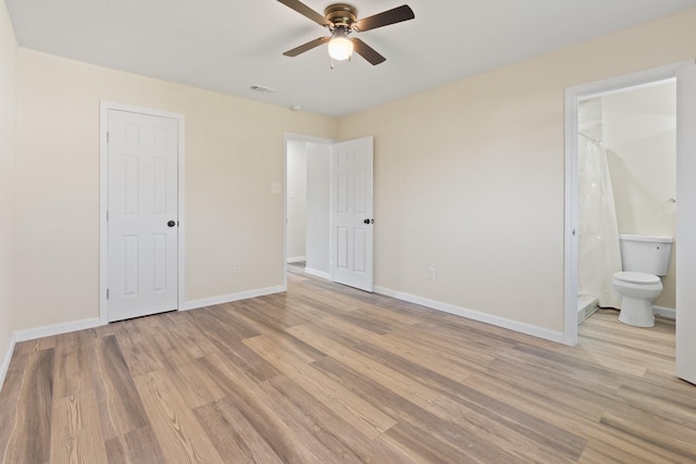 unfurnished bedroom featuring ceiling fan, ensuite bathroom, a closet, and light hardwood / wood-style floors