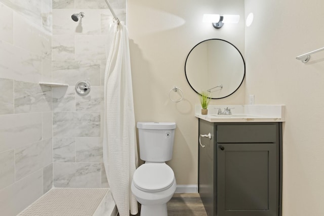 bathroom with toilet, vanity, and curtained shower