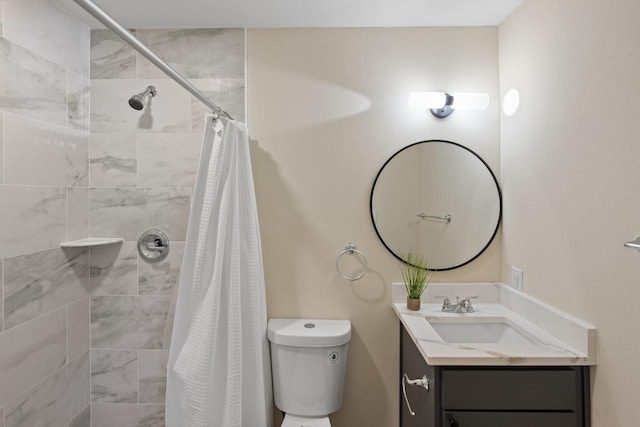 bathroom with vanity, curtained shower, and toilet