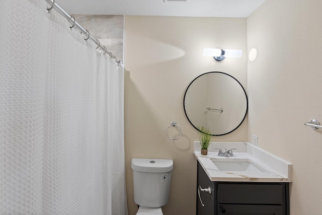 bathroom with vanity, toilet, and a shower with shower curtain