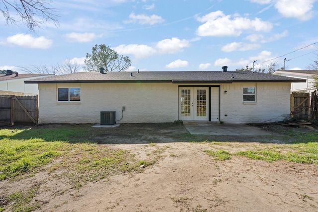 rear view of house with french doors, central AC, a yard, and a patio