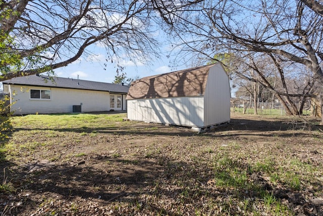 view of property exterior with a storage unit and a yard