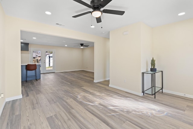 unfurnished living room featuring ceiling fan, wood-type flooring, and french doors