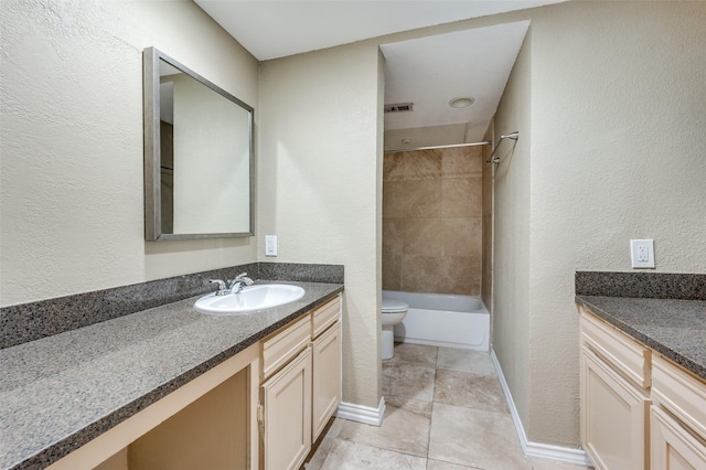 full bathroom with tiled shower / bath, vanity, toilet, and tile patterned flooring