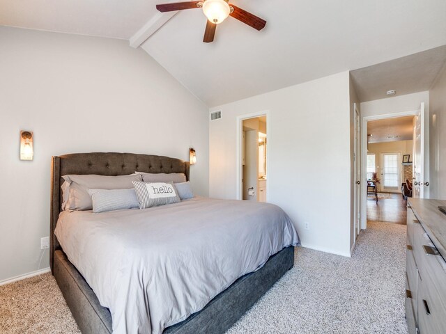 bedroom with connected bathroom, lofted ceiling with beams, ceiling fan, and light carpet