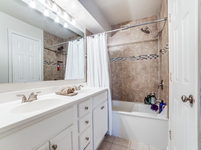 bathroom featuring tile patterned flooring, vanity, and shower / bath combo