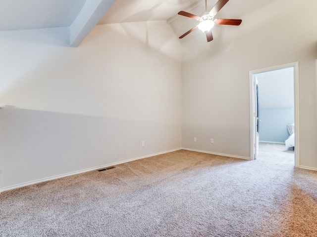 carpeted empty room with high vaulted ceiling and ceiling fan