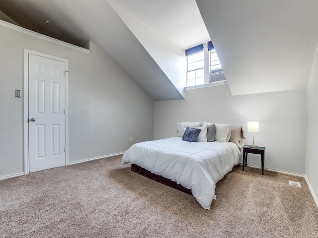 carpeted bedroom with lofted ceiling