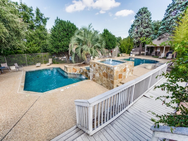 view of swimming pool with an in ground hot tub and a patio