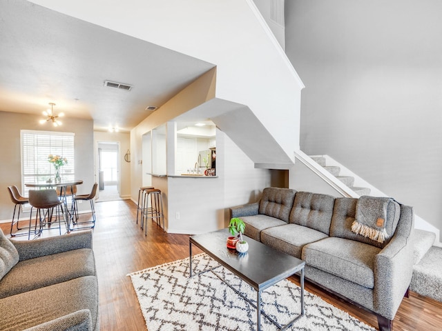 living room featuring an inviting chandelier and hardwood / wood-style floors