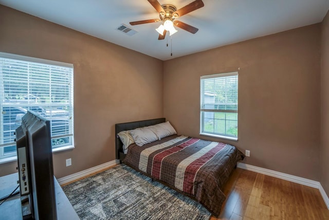 bedroom featuring hardwood / wood-style flooring and ceiling fan