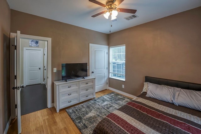 bedroom with light hardwood / wood-style flooring and ceiling fan