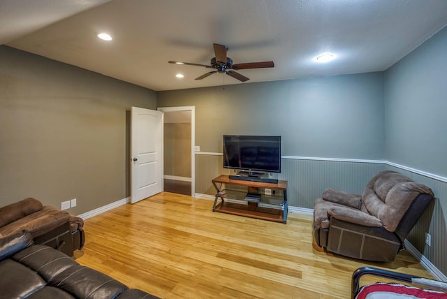 living room featuring hardwood / wood-style flooring and ceiling fan