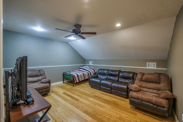 living room featuring ceiling fan, lofted ceiling, and hardwood / wood-style flooring