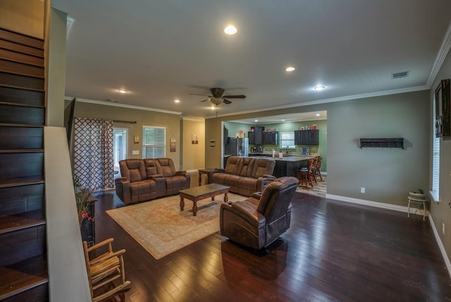 living room featuring dark hardwood / wood-style floors, ceiling fan, and ornamental molding