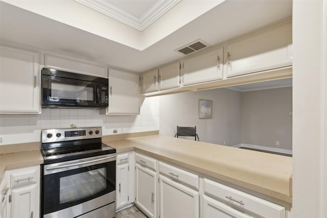 kitchen featuring electric range, white cabinetry, and backsplash