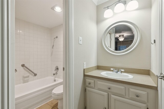 full bathroom with tile patterned flooring, vanity, toilet, and tiled shower / bath