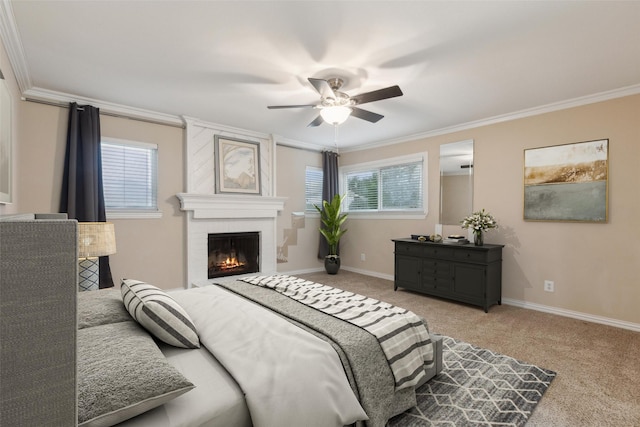 bedroom featuring a fireplace, ceiling fan, crown molding, and light carpet