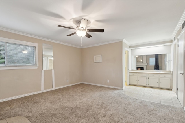 carpeted empty room featuring ceiling fan and ornamental molding