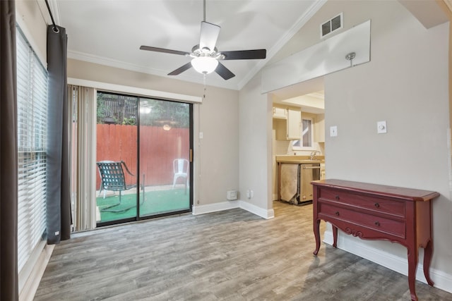 empty room with hardwood / wood-style flooring, plenty of natural light, ceiling fan, and lofted ceiling