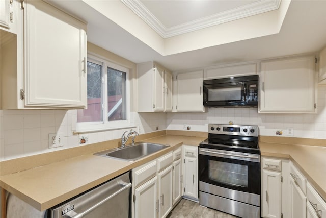 kitchen with sink, white cabinets, ornamental molding, and appliances with stainless steel finishes