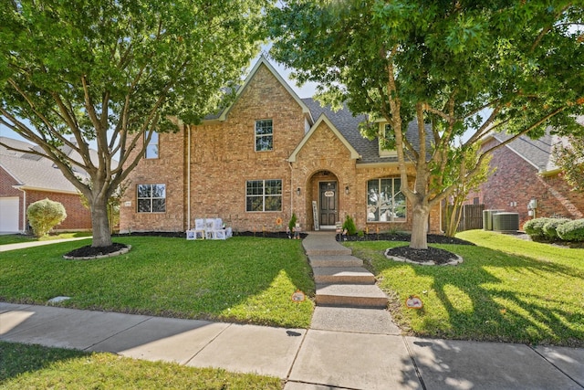 view of front of property featuring a front lawn and central air condition unit