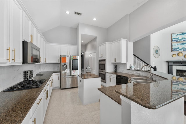 kitchen with a center island, high vaulted ceiling, black appliances, sink, and white cabinetry