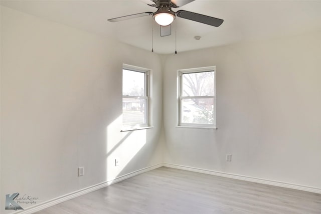 empty room with ceiling fan and light wood-type flooring