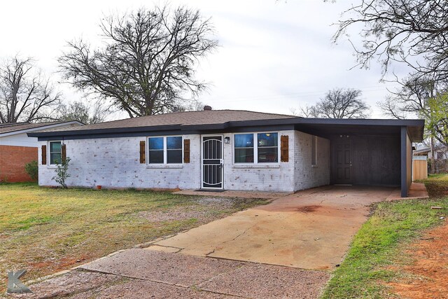 ranch-style home featuring a front yard and a carport